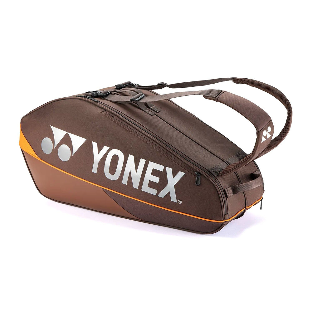 A Yonex multi-ball tennis bag in dark brown with a bright orange accent stripe and white Yonex branding on the front, shown on a clean white background.